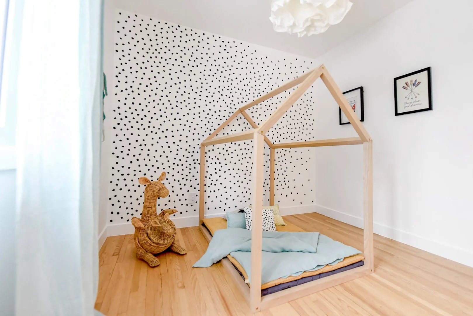 Kid's bedroom in the Montreal bungalow — soft pastel palette and storage built into the joinery.