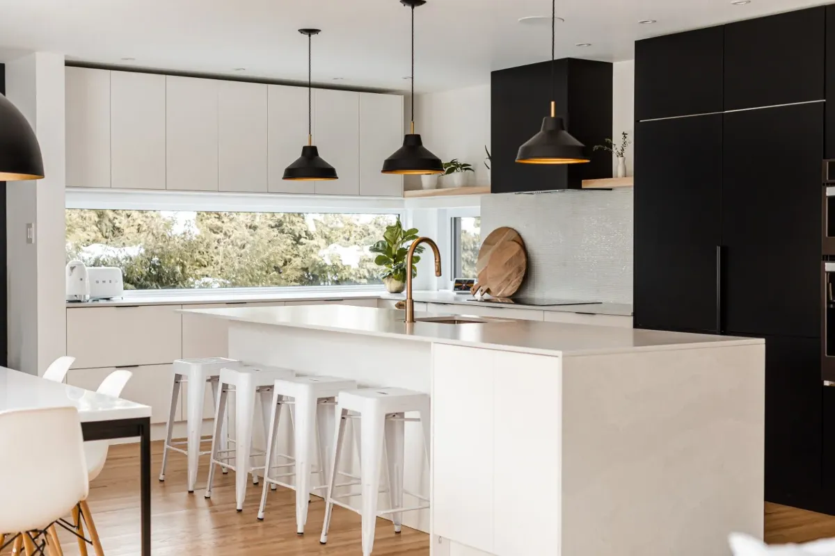 Working side of the Montreal bungalow kitchen — integrated appliances set into black cabinetry.
