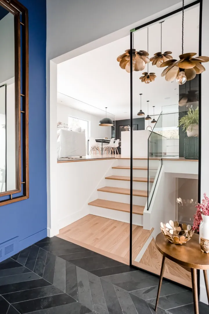 Entryway detail in the Montreal bungalow — natural oak and soft white walls.