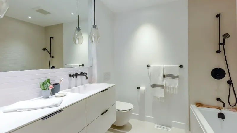 Family bathroom vanity with integrated storage — Montreal bungalow.