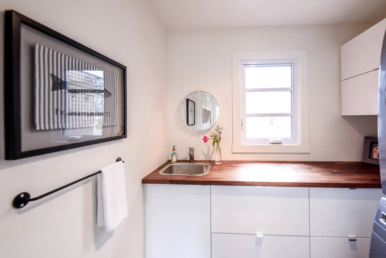 Laundry room in the Montreal cottage — integrated appliances behind custom panels.