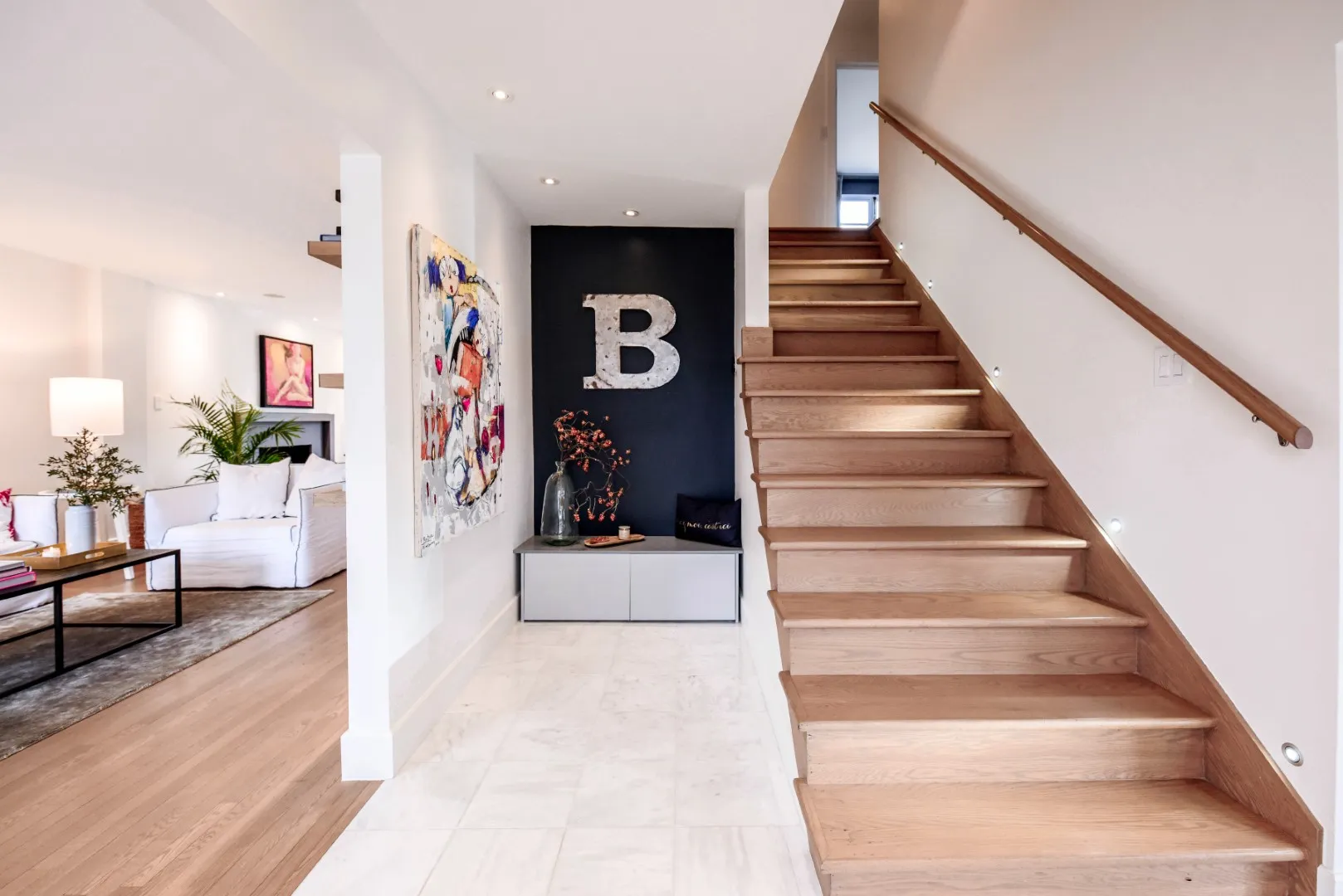Wide entry view — marble tile and painted black accent wall, Montreal cottage.