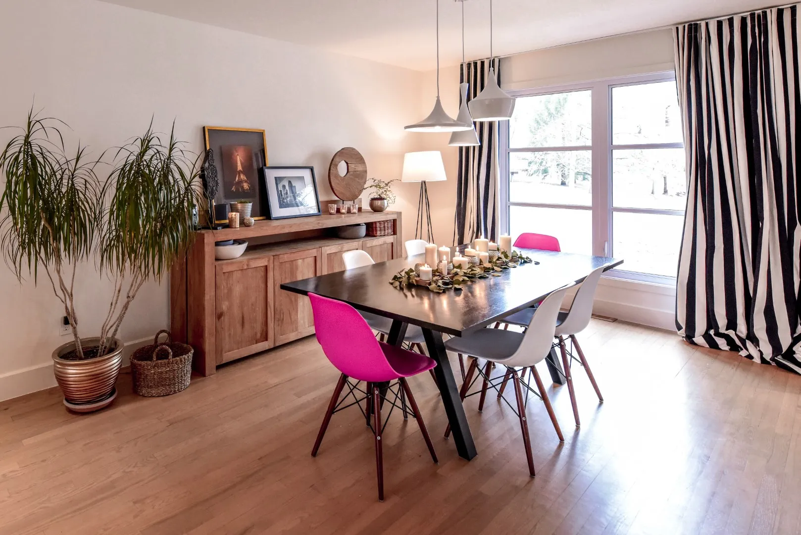 Dining area in the Montreal cottage — framed by French doors and a sculptural pendant.