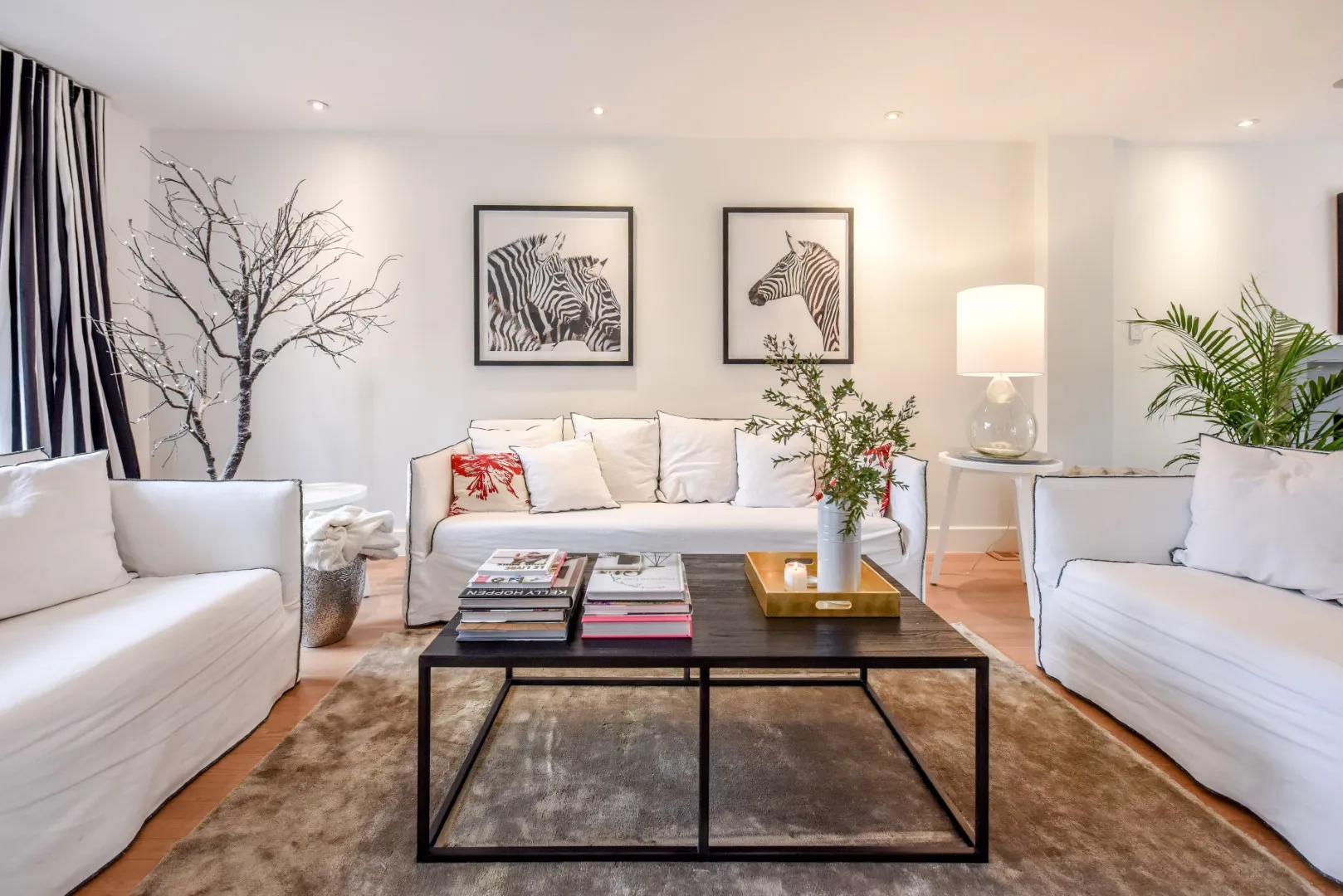 Wide living room view — art wall, gallery sofa arrangement, Montreal cottage.