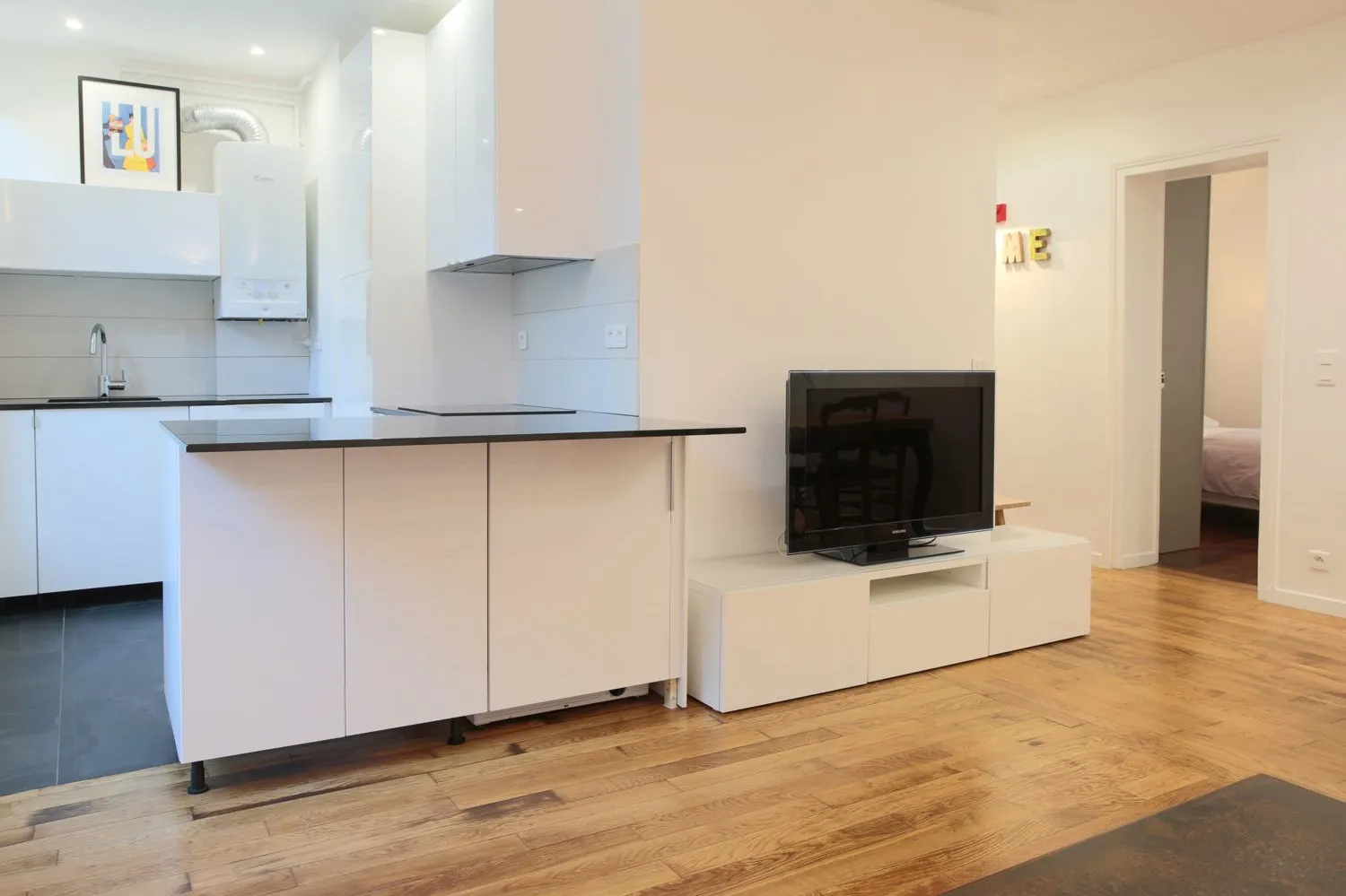 Kitchen counter detail in the Paris 16e rental — neutral palette, refreshed oak floor.
