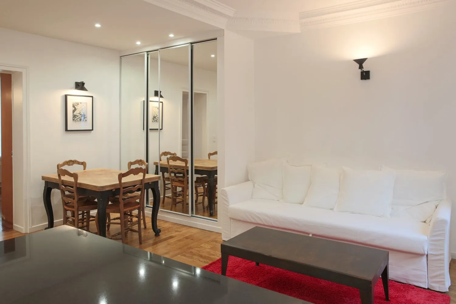 Dining area in the Paris 16e rental — original hardwood floor kept and refinished.