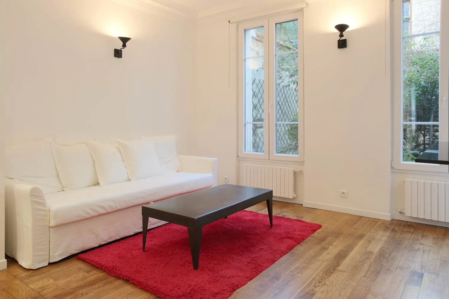Living-dining wide view — Paris 16e rental refit.
